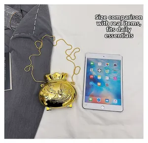 Mini golden fortune bag purse with carp relief compared to an iPad mini for scale