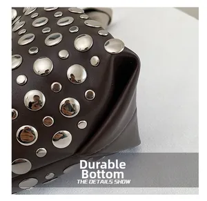 Close-up of the wear-resistant bottom with silver rivets on the vintage leather bag