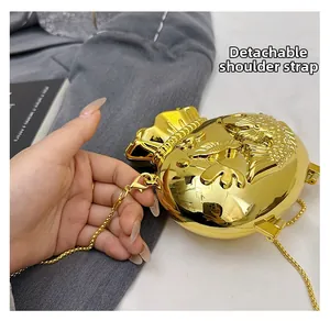 Close-up of golden lucky bag purse featuring embossed goldfish scales and removable chain