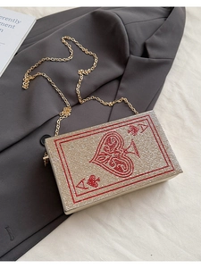 Macro shot of Ace of Spades evening clutch with rhinestones and golden chain