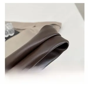Detailed macro view of the comfortable dark brown faux leather shoulder strap texture
