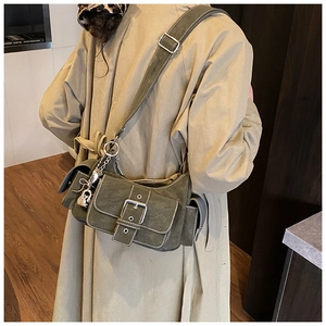 Detail of army green cargo shoulder bag featuring white contrast stitching and silver buckle