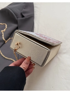 Detail of creative playing card clutch bag with red and white rhinestones and chain strap
