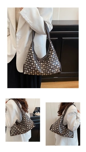 Detail view of vintage dark brown leather hobo bag featuring silver stud embellishments