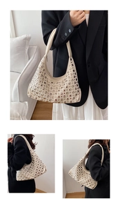 Detail of beige bucket bag with silver metal rivets and wide shoulder strap style