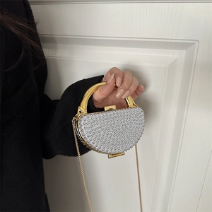 Sparkling rhinestone evening clutch with semi-circular metal handle and chain strap