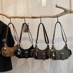 Retro multi-pocket shoulder bags in four vintage colors hanging on a natural branch