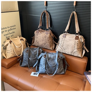 Close-up of vintage tote bags with rivet studs in beige, coffee, khaki, and blue tones