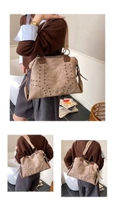 Detail of vintage tote bag featuring vertical metal rivets and distressed leather texture