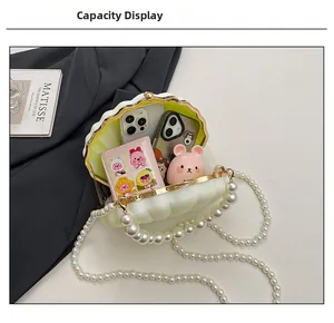 Detail view of the pearl strap acrylic shell bag interior showing storage capacity