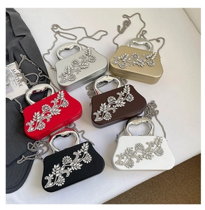Flat lay of evening clutch bags in six colors featuring rhinestone floral patterns