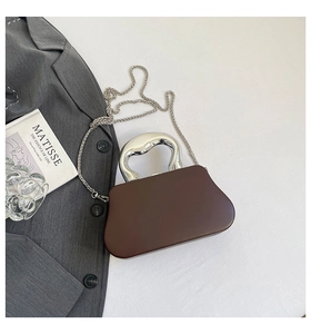 Chic dark brown handbag with unique silver curved handle and detachable chain strap