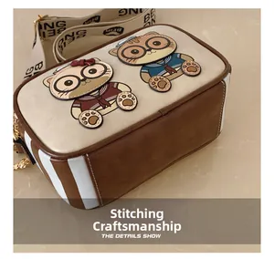 Detailed top view of a cartoon cat crossbody bag showing precise stitching and wide strap