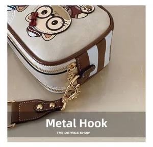 Detail of high-quality gold metal hooks and smooth zipper on cartoon bear crossbody bag
