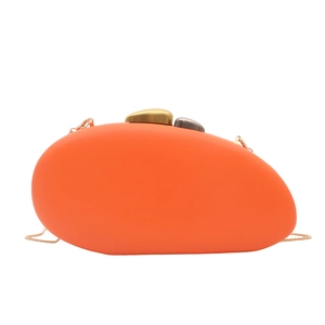 Pebble shaped orange acrylic evening clutch bag with metal clasps and chain strap