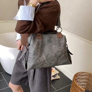 Chic grey tote bag with metallic rivets and dark brown handles for women daily commute
