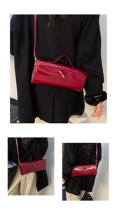 Detail of red patent leather rectangular crossbody bag with golden twist lock buckle