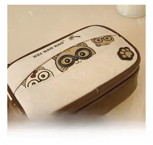 Close-up of cute cartoon cat prints and premium stitching on a brown leather box bag