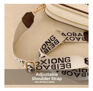Detail of adjustable woven shoulder strap with letter pattern on white crossbody bag