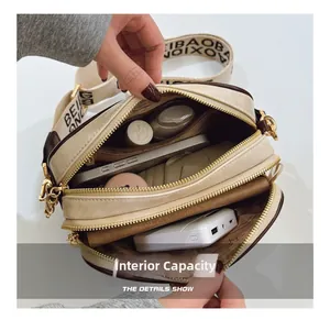 Interior view of beige crossbody bag showing two main compartments and ample storage space