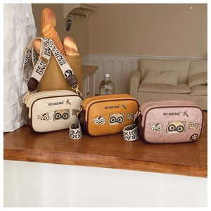 Three colorful cute cat illustration box bags with wide branded logo shoulder straps