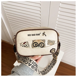 Close-up of off-white cartoon cat crossbody bag with textured PU leather and stylish strap
