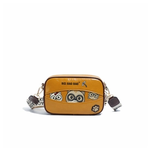 Detail of yellow camera bag with cartoon cat illustration and embroidered dragonfly
