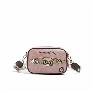 Close-up of pink textured crossbody bag featuring a cute cartoon cat print and wide strap