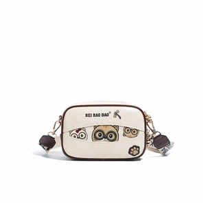 Detail of cream crossbody box bag with cartoon cat print and branded wide strap