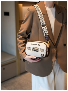 Chic beige box bag featuring cat illustrations and a decorative jacquard strap