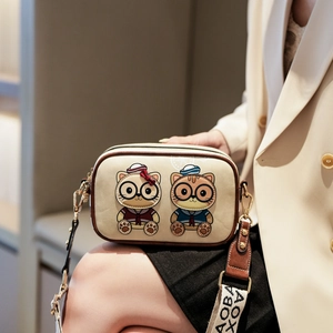 Cream cartoon cat camera bag with wide strap and embroidery details for women