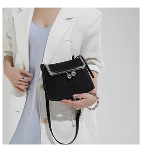 Detail of vintage black shell bag with silver metal frame and double sphere clasp