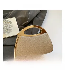 Detail of champagne gold glitter evening bag with metallic hollow handle and chain strap