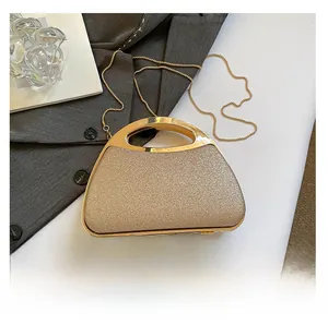 Detailed shot of sequin evening clutch with metal handle and chain next to a smartphone