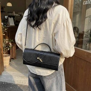 Chic black snakeskin pattern crossbody bag with a vintage gold twist lock for women