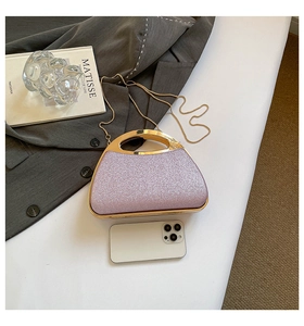 Purple sequin evening bag with gold metal handle and chain shown with lifestyle props