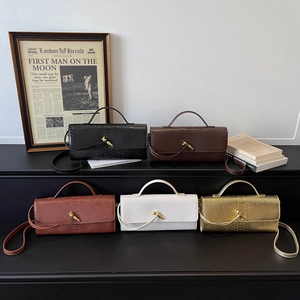 Elegant snakeskin textured evening clutch bags in multiple colors with gold knot buckles