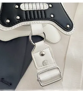 Macro view of silver hardware hooks and rivet details on the guitar-shaped bag