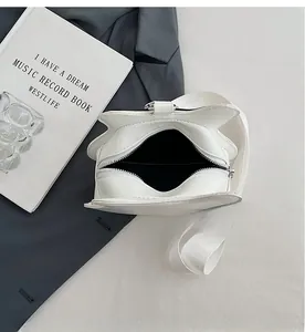 White guitar-shaped star bag with black interior lining and silver zipper detail