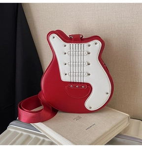 Macro detail of guitar-shaped crossbody bag with red and white PU leather and metal studs