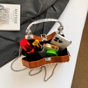 Interior view showing the large capacity of the brown leather bag with pearl studs