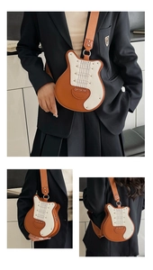 Detailed close-up of guitar-shaped crossbody bag with rivet accents and woven strap