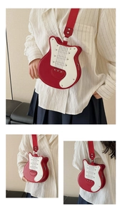 Detailed view of guitar shaped crossbody bag with red leather and metallic stud accents