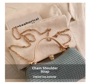 Detailed view of blue glitter fabric clutch with gold metal handle and luxury jewel clasp