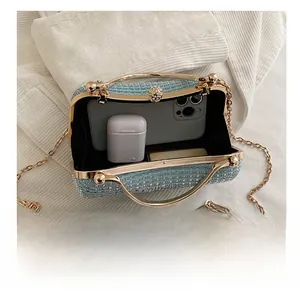 Detail view of the blue tweed evening bag interior showing its capacity for small essentials