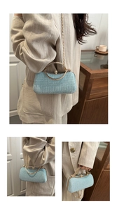 Detail of light blue rhinestone box bag featuring gold ring handle and versatile chain strap