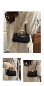 Detailed view of a black sequin box clutch bag with gold ring handle and chain strap