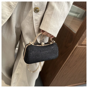 Detail of black sequined evening bag with gold handle and chain strap for parties