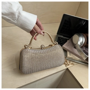 Champagne gold evening clutch with glitter texture and decorative diamond clasp