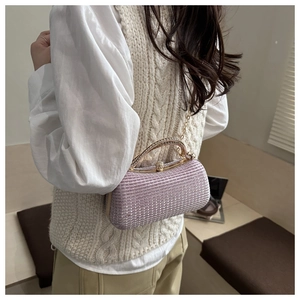 Detail of lavender evening clutch bag with sequins and sparkling rhinestone handle